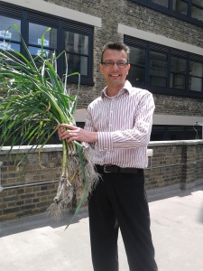 Dan holding a large bunch of garlic